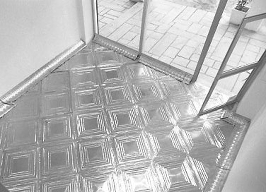 ONCE UPON A TIME... ICE BOX<br />
1994 Ongoing<br />
Balcony View<br />
Floor: American Prest-Plate Ceiling Tin Installed On Top of Gallery Floor Left for Viewers to Destroy through Abrasion with Actual Gallery Floor, Viewer Imprints,<br /> Tracks, and Traffic<br />
Variable Dimensions<br />