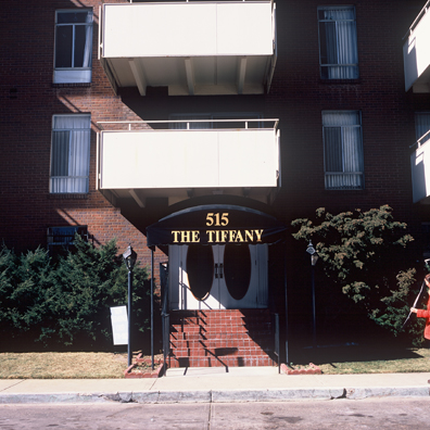 DISPLACED DENVER: THE TIFFANY<br/>
2000 Ongoing <br/>
Cibachrome Print <br/>
Series of Denver Apartment Buildings Named After Famous Politicians, Artists, Landmarks, Neighborhoods, Beaches, Styles, Museums, Islands, Cocktails, Clothing, Pirates, Warriors, Automobiles, Restaurants, Race Tracks, Festivals, Writers, Cities, Explorers, Teams, Palaces, Stores, Poets, Song Writers, Hotels, Magazines, Fictional Places, Architectural Elements, Holidays, Etc <br/ >