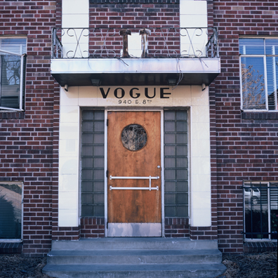 DISPLACED DENVER: THE VOGUE<br/>
2000 Ongoing <br/>
Cibachrome Print <br/>
Series of Denver Apartment Buildings Named After Famous Politicians, Artists, Landmarks, Neighborhoods, Beaches, Styles, Museums, Islands, Cocktails, Clothing, Pirates, Warriors, Automobiles, Restaurants, Race Tracks, Festivals, Writers, Cities, Explorers, Teams, Palaces, Stores, Poets, Song Writers, Hotels, Magazines, Fictional Places, Architectural Elements, Holidays, Etc <br/ >