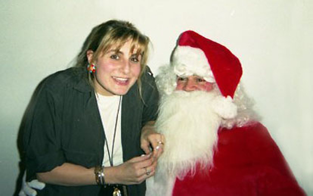 “YOU BETTER WATCH OUT”<br />
1991 Ongoing<br />
Happening: Professional Santa Claus Asking Viewers‚ “If They Have Been Bad or Good”‚ and Delighting in Milk and Cookies Left by the Artist for Santa to Devour<br />
Photograph of Happening: Karin Bravin Confides in Santa Her True Desire for an End to the Fruit Cake Tradition <br />