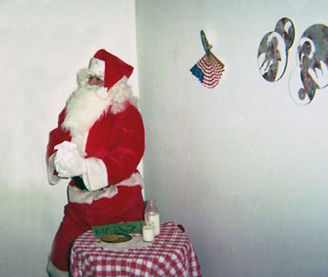 “YOU BETTER WATCH OUT”<br />
1991 Ongoing<br />
Happening: Professional Santa Claus Asking Viewers‚ “If They Have Been Bad or Good”‚ and Delighting in Milk and Cookies Left by the Artist for Santa to Devour<br />
Photograph of Happening: Santa‚ Thinking He Sees Ryan Seacrest‚ Decides to Make a Foray into the Candy Deprived Crowd<br />