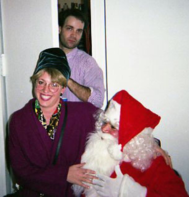 “YOU BETTER WATCH OUT”<br />
1991 Ongoing<br />
Happening: Professional Santa Claus Asking Viewers‚ “If They Have Been Bad or Good”‚ and Delighting in Milk and Cookies Left by the Artist for Santa to Devour<br />
Photograph of Happening: John Post Lee Walks in on “Mommy Kissing Santa Claus”<br />