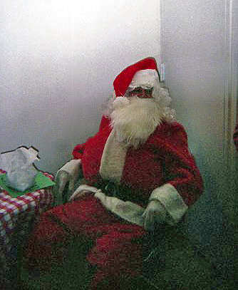 “YOU BETTER WATCH OUT”<br />
1991 Ongoing<br />
Happening: Professional Santa Claus Asking Viewers‚ “If They Have Been Bad or Good”‚ and Delighting in Milk and Cookies Left by the Artist for Santa to Devour<br />
Photograph of Happening: Santa Smoking Break<br />