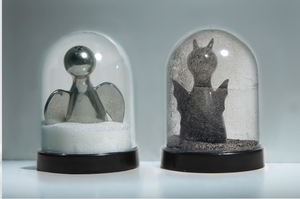 SHAKE: AN ACCUMULATED GIFT COLLECTION OF SALT AND PEPPER SHAKERS <br/>
1991 Ongoing <br/>
Detail: Gift of Mousumi Shaw (Angel Devil Shakers)<br/>
Snow Globes Altered to Become Functioning Salt and Pepper Shakers, Each Filled with Salt and Pepper, and when Used, the Diminishing Salt and Pepper Reveals the Actual Accumulated Gift Collection of Shakers<br/>
3 1/2”H x 2 1/2” in Diameter<br/>